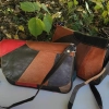 Genuine leather bag with three zipped pockets and a long handle