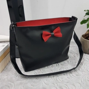 Leather bag with red ribbon