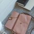 Stylish pink bag with compartments and handle