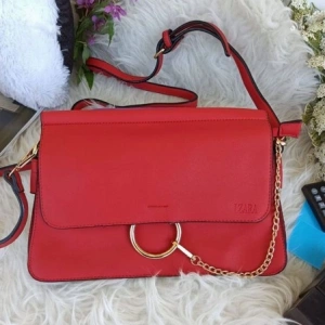 Stylish red bag with compartments and handle