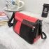 Genuine leather bag in black with red, with three pockets